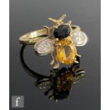 A 9ct hallmarked citrine, sapphire and diamond ring modelled as a fly with sapphire and citrine