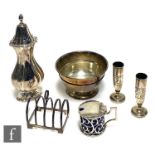 Six items of hallmarked silver to include a small bowl, a toast rack, a sugar castor, a mustard
