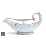 An 18th Century Worcester Cos Lettuce shape sauce boat, the moulded body sparsely decorated with