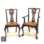 A set of six Chippendale style carved mahogany dining chairs, pierced vase splats below undulating