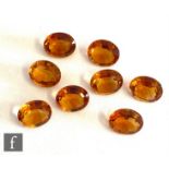 Eight loose cut and polished oval orange citrine stones each approximately length 12mm, width