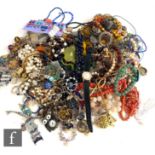 A parcel lot of assorted costume jewellery to include beads, brooches, watches, bracelets, earrings,