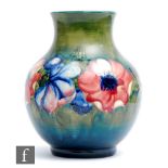 William Moorcroft - A large footed vase of globe and shaft form decorated in the Anemone pattern