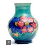 William Moorcroft - A large vase of footed globe and shaft form decorated in the Clematis pattern