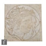 Unknown - A square white marble plaque carved with a side portrait of Medusa style figure within a