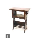 In the manner of Liberty & Co - A small oak cabinet bookcase, the rectangular overhanging top
