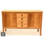 W.H. Russell - Gordon Russell Furniture - A Cotswold School oak sideboard, fitted with a central