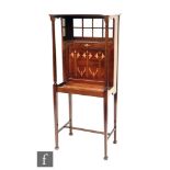 Liberty & Co - A mahogany writing cabinet, the canopy top over a sectional glazed panel and a fall