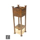 In the manner of Shapland & Petter - An oak jardinière stand of square form, with riveted copper