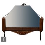 Unknown - An Art Deco mirror of geometric form, with a carved wood half frame and tassels, height