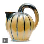 Lacourbas - An early 20th Century French Art Nouveau jug formed as a melon with high loop handle and