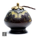 Galle - An early 20th Century French cameo glass lamp, of compressed footed ovoid form, cased in