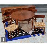 Stonehill Furniture - A six piece dining suite, comprising part rosewood veneered sideboard,