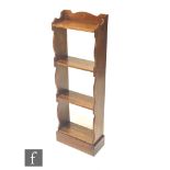Unknown - An Arts and Crafts oak open four-tier bookcase of small proportions, with fret-cut side