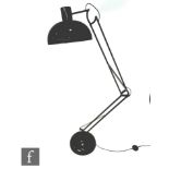 After Anglepoise - A black floor lamp, the domed base extending to an adjustable arm and shade,