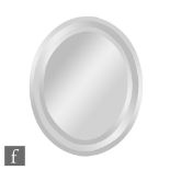 Unknown - An Art Deco wall mirror of oval form, the stepped panel with a bevelled edge, height 77cm,