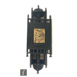An Aesthetic Movement ebonised wall hanging single door corner cabinet, with turned galleries and