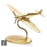 Unknown - A late 1930s brass desk ornament in the form of a stylised Spitfire mounted to a swept