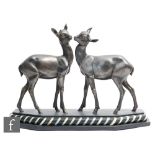 Irenee Rochard - An Art Deco bronzed spelter study of two standing fawns, circa 1930, mounted on a