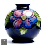William Moorcroft - A small footed ovoid vase decorated in the Clematis pattern, impressed mark,
