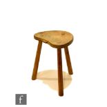 Robert 'Mouseman' Thompson - A kidney shaped Cow stool, raised to three chamfered legs, with