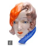 Goldscheider - A wall mask modelled as a lady in profile wearing a red beret and a blue jacket,