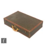 Louis Vuitton - A large Alzer hard case suitcase trunk, monogrammed leather with gold hardware,