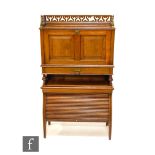 James Shoolbred - A students walnut combination writing desk and bookcase, with fret-cut gallery
