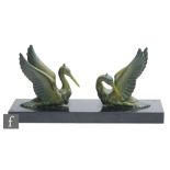 Unknown - A French Art Deco green patinated spelter study modelled as two stylised pelicans, mounted