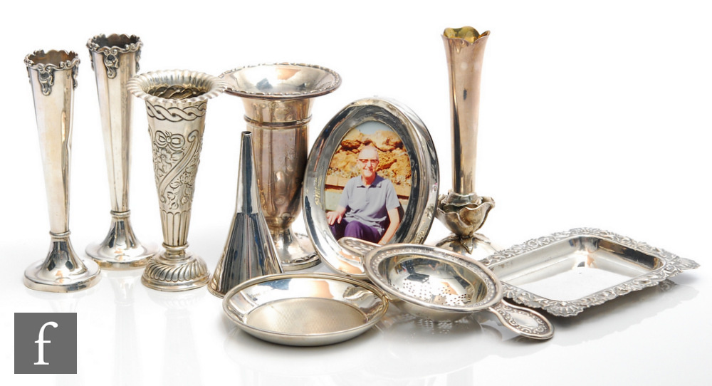 A small parcel lot of assorted hallmarked silver items to include five bud vases, a funnel, a tea