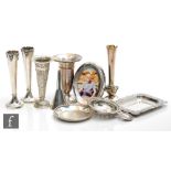 A small parcel lot of assorted hallmarked silver items to include five bud vases, a funnel, a tea
