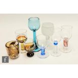 An assorted collection of studio drinking glasses, of  various decorations and makers, including