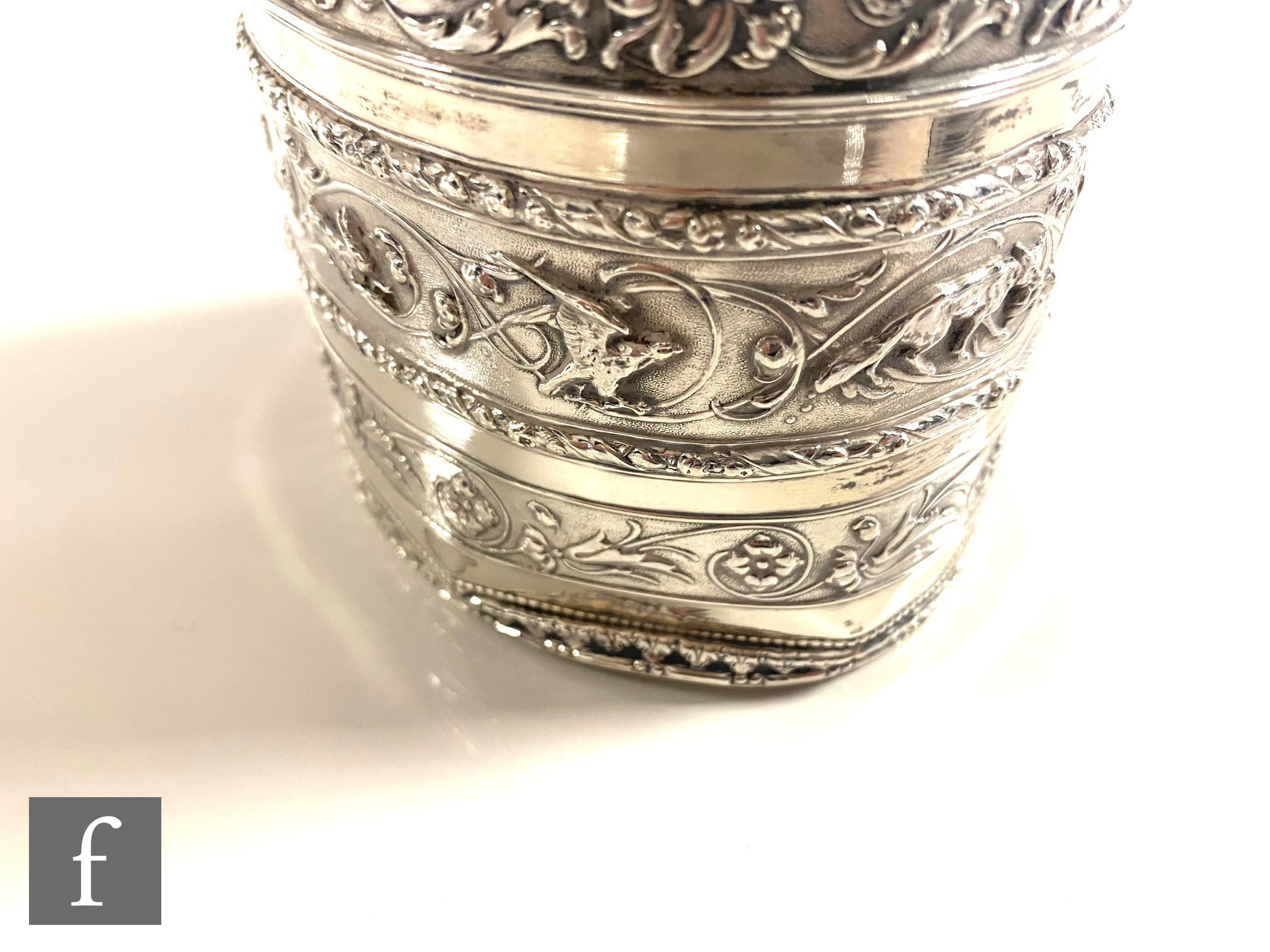 A hallmarked silver oval tea caddy with banded embossed foliate scroll decoration to body and pull - Image 2 of 5