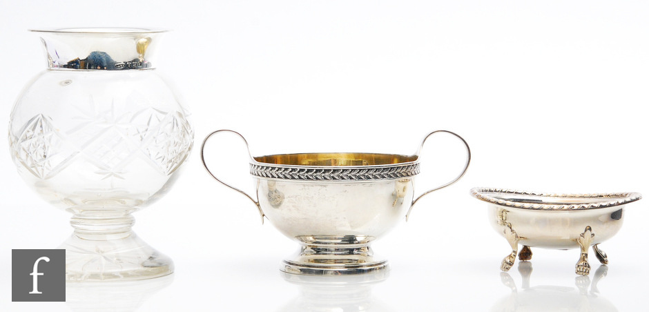 A hallmarked silver twin handled sugar basin with a silver open salt, total weight 6.5oz, and a