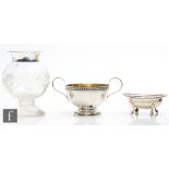A hallmarked silver twin handled sugar basin with a silver open salt, total weight 6.5oz, and a