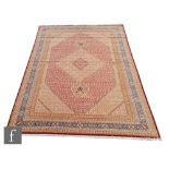 An very large Bidjar carpet, the hand knotted wool rug with central diamond design, within a