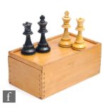 A 20th Century stained boxwood chess set in sliding case, complete.