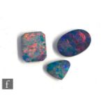 Three cut and polished loose, unused opal doublet stones, oval, canted rectangular and cushioned