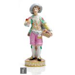 A 19th Century Dresden type figure of a gentleman fruit and flower seller, wearing a patterned