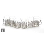 A set of six hallmarked silver toddy cups each with a plain glass within a pierced foliate decorated