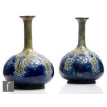 A pair of late 19th Century Royal Doulton solifleur vases of compressed form with a tall flared