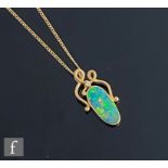 A 14ct oval opal doublet and diamond set pendant, collar set opal below a single diamond,