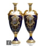 A pair of 19th Century Coalport pedestal vases each decorated with a hand painted cartouche panel,