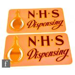 Two Perspex pictorial advertising signs for NHS Dispensing, light orange and green, 23cm x 45cm.