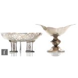 Two hallmarked silver bon bon dishes one with part pierced decoration raised on three strut legs the