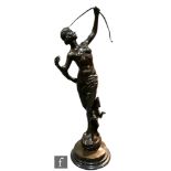 A late 20th Century bronze figure in the Art Deco style modelled as a semi clad maiden holding a bow