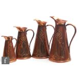 A set of four Art Nouveau graduated copper jugs of tapered form by Joseph Sankey & Sons, decorated