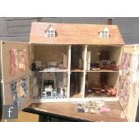 A contemporary two storey dolls house with hinged roof attic, split front opening and interior walls