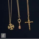 Three 9ct hallmarked pendants, a crucifix, a loving spoon and a Celtic cross, each suspended from