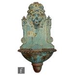 A cast iron Victorian style lion head wall fountain, the lower campana form basin extending to an